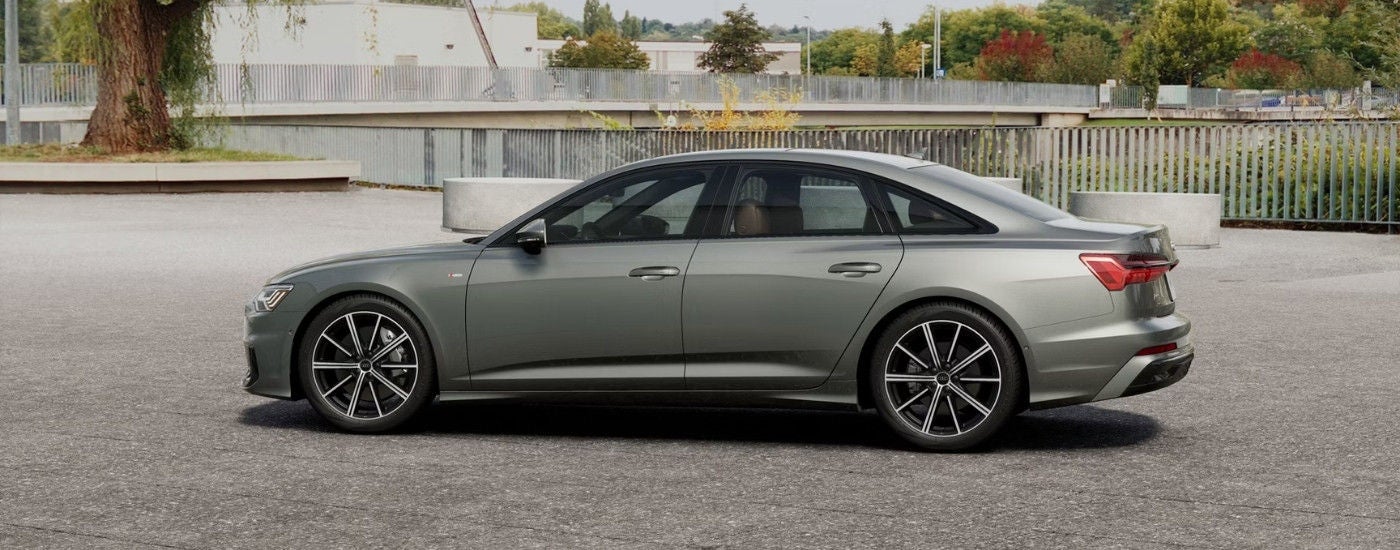 Grey 2025 Audi A6 parked near a bridge